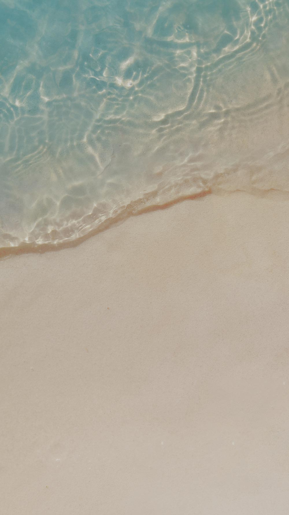 Close-up of water meeting sand on a beach